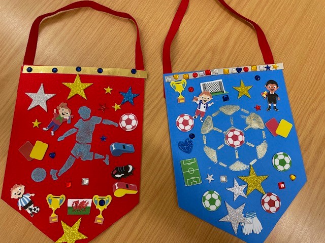 Felt red and blue pendant football fan flags decorated by children.